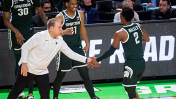 Michigan State Spartans head coach Tom Izzo high fives guard Tyson Walker during the second round of the 2022 NCAA tournament at Bon Secours Wellness Arena in Greenville, S.C., on Sunday, March 20, 2022.