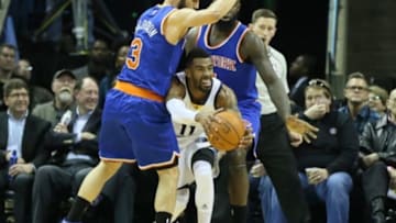 Jan 5, 2015; Memphis, TN, USA; Memphis Grizzlies guard Mike Conley (11) looks to pass as New York Knicks guards Jose Calderon (3) and Quincy Acy (4) defend at FedExForum. Memphis defeated New York 105-83. Mandatory Credit: Nelson Chenault-USA TODAY Sports