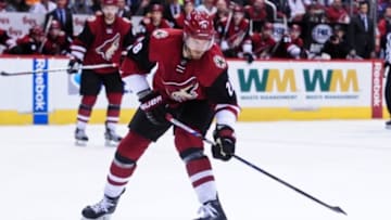 Feb 15, 2016; Glendale, AZ, USA; Arizona Coyotes defenseman Jarred Tinordi (28) shoots the puck during the second period against the Montreal Canadiens at Gila River Arena. Mandatory Credit: Matt Kartozian-USA TODAY Sports