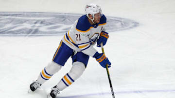 Feb 13, 2022; Montreal, Quebec, CAN; Buffalo Sabres right wing Kyle Okposo (21) skates with the puck against Montreal Canadiens during the first period at Bell Centre. Mandatory Credit: Jean-Yves Ahern-USA TODAY Sports