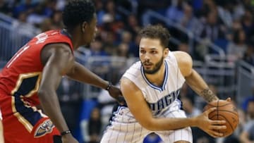 Dec 28, 2015; Orlando, FL, USA; New Orleans Pelicans guard Jrue Holiday (left) defends Orlando Magic forward Evan Fournier (10) during the fourth quarter of a basketball game at Amway Center. The Magic won 104-89. Mandatory Credit: Reinhold Matay-USA TODAY Sports