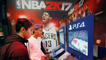 PARIS, FRANCE - OCTOBER 28: Gamers play the video game 'NBA 2K 17' developed by Visual Concepts and published 2K Sports on Sony PlayStation game consoles PS4 during the 'Paris Games Week' on October 28, 2016 in Paris, France. 'Paris Games Week' is an international trade fair for video games to be held from October 27 to October 31, 2016. (Photo by Chesnot/Getty Images)