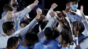 GREENSBORO, NORTH CAROLINA - MARCH 12: The North Carolina Tar Heels huddle prior to the first half of their semifinals game against the Florida State Seminoles in the ACC Men's Basketball Tournament at Greensboro Coliseum on March 12, 2021 in Greensboro, North Carolina. (Photo by Jared C. Tilton/Getty Images)