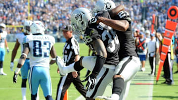 Sep 25, 2016; Nashville, TN, USA; Oakland Raiders cornerback TJ Carrie (38) celebrates with cornerback Sean Smith (21) after a defensive stop late in the fourth quarter against the Tennessee Titans at Nissan Stadium. The Raiders won 17-10. Mandatory Credit: Christopher Hanewinckel-USA TODAY Sports