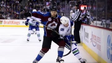 Feb 9, 2016; Denver, CO, USA; Colorado Avalanche center John Mitchell (7) checks Vancouver Canucks right wing Derek Dorsett (15) in the third period at the Pepsi Center. The Canucks defeated the Avalanche 3-1. Mandatory Credit: Ron Chenoy-USA TODAY Sports