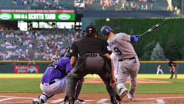 DENVER, CO - AUGUST 10: Yasmani Grandal #9 of the Los Angeles Dodgers hits a first inning RBI single against the Colorado Rockies at Coors Field on August 10, 2018 in Denver, Colorado. (Photo by Dustin Bradford/Getty Images)