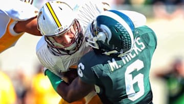 Sep 27, 2014; East Lansing, MI, USA; Wyoming Cowboys quarterback Colby Kirkegaard (11) is sacked by Michigan State Spartans linebacker Mylan Hicks (6) during the 2nd half of a game at Spartan Stadium. MSU won 56-14. Mandatory Credit: Mike Carter-USA TODAY Sports
