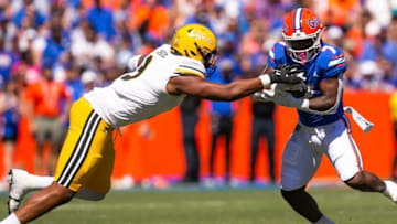 Missouri Tigers defensive lineman Isaiah McGuire (9) tries to tackle Florida Gators running back Trevor Etienne (7) in the first half at Steve Spurrier Field at Ben Hill Griffin Stadium in Gainesville, FL on Saturday, October 8, 2022. [Doug Engle/Gainesville Sun]Ncaa Football Florida Gators Vs Missouri Tigers