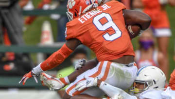 Clemson running back Travis Etienne(9) leaps past The Citadel defensive back Chris Beverly(17) during the first quarter of the game Saturday, Sept. 19, 2020 at Memorial Stadium in Clemson, S.C.Clemson The Citadel Ncaa Football