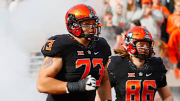 STILLWATER, OK - NOVEMBER 17: Offensive lineman Teven Jenkins #73 and tight end Baron Odom #86 of the Oklahoma State Cowboys run onto the field for a game against the West Virginia Mountaineers on November 17, 2018 at Boone Pickens Stadium in Stillwater, Oklahoma. Oklahoma State won 45-41. (Photo by Brian Bahr/Getty Images)