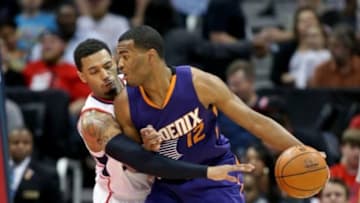 Apr 7, 2015; Atlanta, GA, USA; Atlanta Hawks forward Mike Scott (32) guards Phoenix Suns forward T.J. Warren (12) in the fourth quarter of their game at Philips Arena. The Hawks won 96-69. Mandatory Credit: Jason Getz-USA TODAY Sports