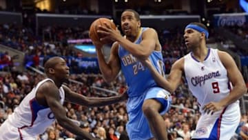 Dec 21, 2013; Los Angeles, CA, USA; Denver Nuggets point guard Andre Miller (24) drives the lane past Los Angeles Clippers shooting guard Jamal Crawford (11) and small forward Jared Dudley (9) in the first half of the game at Staples Center. Mandatory Credit: Jayne Kamin-Oncea-USA TODAY Sports