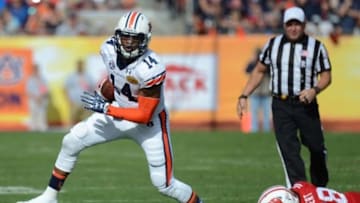 Jan 1, 2015; Tampa, FL, USA; Auburn Tigers quarterback Nick Marshall (14) runs the ball in the second half against the Wisconsin Badgers of the 2015 Outback Bowl at Raymond James Stadium. The Wisconsin Badgers defeated the Auburn Tigers 34-31 in overtime. Mandatory Credit: Jonathan Dyer-USA TODAY Sports