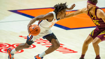 Dec 15, 2020; Champaign, Illinois, USA; Illinois Fighting Illini guard Ayo Dosunmu (11) drives against Minnesota Golden Gophers guard Gabe Kalscheur (22) during the first half at the State Farm Center. Mandatory Credit: Patrick Gorski-USA TODAY Sports