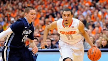 Dec 28, 2013; Syracuse, NY, USA; Syracuse Orange guard Tyler Ennis (11) drives to the basket against the defense of Villanova Wildcats guard Ryan Arcidiacono (15) during the first half at the Carrier Dome. Mandatory Credit: Rich Barnes-USA TODAY Sports