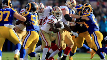 LOS ANGELES, CA - DECEMBER 31: Carlos Hyde #28 of the San Francisco 49ers rushes for a touchdown as Cory Littleton #58 and Bryce Hager #54 of the Los Angeles Rams defend during the first half of a game at Los Angeles Memorial Coliseum on December 31, 2017 in Los Angeles, California. (Photo by Sean M. Haffey/Getty Images)