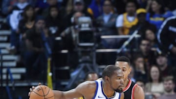 OAKLAND, CA - DECEMBER 11: Kevin Durant #35 of the Golden State Warriors dribbling the ball backs in on CJ McCollum #3 of the Portland Trail Blazers during an NBA basketball game at ORACLE Arena on December 11, 2017 in Oakland, California. NOTE TO USER: User expressly acknowledges and agrees that, by downloading and or using this photograph, User is consenting to the terms and conditions of the Getty Images License Agreement. (Photo by Thearon W. Henderson/Getty Images)