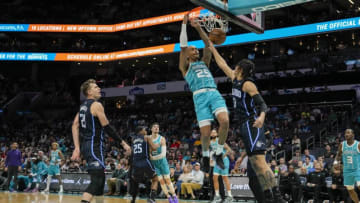 Apr 7, 2022; Charlotte, North Carolina, USA; Charlotte Hornets forward P.J. Washington (25) dunks the ball against Orlando Magic guard R.J. Hampton (13) during the first quarter at Spectrum Center. Mandatory Credit: Jim Dedmon-USA TODAY Sports