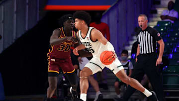 Nov 24, 2021; Nassau, BHS; Michigan State Spartans forward Malik Hall (25) drives to the basket as Loyola Ramblers forward Aher Uguak (30) defends during the second half of the 2021 Battle 4 Atlantis Tournament at Imperial Arena. Mandatory Credit: Kevin Jairaj-USA TODAY Sports