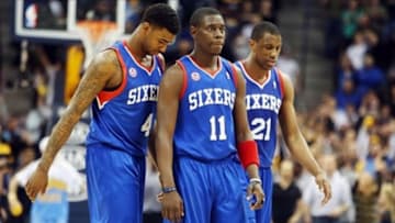 Mar 21, 2013; Denver, CO, USA; Philadelphia 76ers players Jrue Holiday (11) , Dorell Wright (4) , and Thaddeus Young (21) react during the second half against the Denver Nuggets at the Pepsi Center. The Nuggets won 101-100. Mandatory Credit: Chris Humphreys-USA TODAY Sports