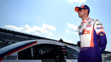 LONG POND, PENNSYLVANIA - JULY 27: Denny Hamlin, driver of the #11 FedEx Ground Toyota, walks on the grid during qualifying for the Monster Energy NASCAR Cup Series Gander RV 400 at Pocono Raceway on July 27, 2019 in Long Pond, Pennsylvania. (Photo by Jared C. Tilton/Getty Images)