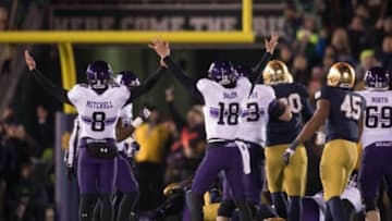 Nov 15, 2014; South Bend, IN, USA; Northwestern Wildcats kicker Jack Mitchell (8) and holder Christian Salem (18) react after a field goal in the fourth quarter against the Notre Dame Fighting Irish at Notre Dame Stadium. Northwestern won 43-30 in overtime. Mandatory Credit: Matt Cashore-USA TODAY Sports