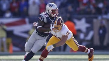 Nov 8, 2015; Foxborough, MA, USA; New England Patriots running back Dion Lewis (33) is tackled by Washington Redskins outside linebacker Ryan Kerrigan (91) during the first quarter at Gillette Stadium. Mandatory Credit: Greg M. Cooper-USA TODAY Sports