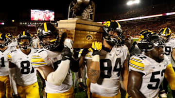 AMES, IA - SEPTEMBER 14: Defensive end Chauncey Golston #57, left, and defensive end A.J. Epenesa #94 of the Iowa Hawkeyes carry the Iowa Corn Cy-Hawk Trophy off the field after winning 18-17 over the Iowa State Cyclones at Jack Trice Stadium on September 14, 2019 in Ames, Iowa. The Iowa Hawkeyes won 18-17 over the Iowa State Cyclones. (Photo by David Purdy/Getty Images)