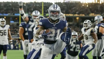 ARLINGTON, TX - DECEMBER 15: Dallas Cowboys running back Ezekiel Elliott (21) scores a touchdown during the game between the Dallas Cowboys and the Los Angeles Rams on December 15, 2019 at the AT&T Stadium in Arlington, Texas. (Photo by Matthew Pearce/Icon Sportswire via Getty Images)