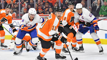 Feb 6, 2023; Philadelphia, Pennsylvania, USA; Philadelphia Flyers right wing Travis Konecny (11) picks up loose puck away from New York Islanders center Bo Horvat (14) during the first period at Wells Fargo Center. Mandatory Credit: Eric Hartline-USA TODAY Sports