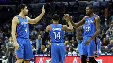 Dec 8, 2015; Memphis, TN, USA; Oklahoma City Thunder forwards Mike Collison (4) and Kevin Durant (35) celebrate with guard D.J. Augustin (14) react after scoring against the Memphis Grizzlies at FedExForum. Oklahoma City defeated Memphis 125-88. Mandatory Credit: Nelson Chenault-USA TODAY Sports