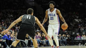 Dec 18, 2016; Philadelphia, PA, USA; Philadelphia 76ers center Joel Embiid (21) dribbles as Brooklyn Nets center Brook Lopez (11) defends during the first quarter of the game at the Wells Fargo Center. Mandatory Credit: John Geliebter-USA TODAY Sports