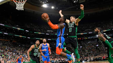 OKC Thunder's Dennis Schroder #17 drives through the paint against Jayson Tatum #0. (Photo by Brian Babineau/NBAE via Getty Images)
