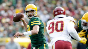 GREEN BAY, WISCONSIN - OCTOBER 24: Aaron Rodgers #12 of the Green Bay Packers drops back to pass against the Washington Football Team at Lambeau Field on October 24, 2021 in Green Bay, Wisconsin. Green Bay defeated Washington 24-10. (Photo by John Fisher/Getty Images)