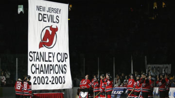 New Jersey Devils watch a Stanley Cup Champions banner (Photo by Chris Trotman/Getty Images)