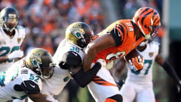 Nov 2, 2014; Cincinnati, OH, USA; Jacksonville Jaguars linebacker J.T. Thomas (52) and Jacksonville Jaguars cornerback Demetrius McCray (35) tackle Cincinnati Bengals tight end Jermaine Gresham (84) in the second half at Paul Brown Stadium. Cincinnati defeated Jacksonville 33-23. Mandatory Credit: Mark Zerof-USA TODAY Sports