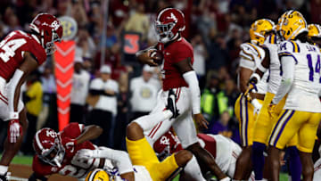 Nov 4, 2023; Tuscaloosa, Alabama, USA; Alabama Crimson Tide quarterback Jalen Milroe (4) carries the ball in for a touchdown against the LSU Tigers during the first half at Bryant-Denny Stadium. Mandatory Credit: Butch Dill-USA TODAY Sports