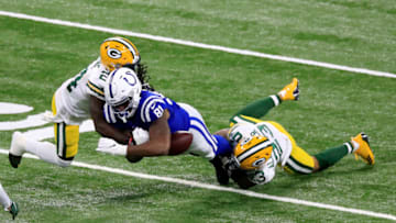 INDIANAPOLIS, INDIANA - NOVEMBER 22: Mo Alie-Cox #81 of the Indianapolis Colts makes a reception between Raven Greene #24 and Jaire Alexander #23 of the Green Bay Packers during the first quarter in the game at Lucas Oil Stadium on November 22, 2020 in Indianapolis, Indiana. (Photo by Andy Lyons/Getty Images)