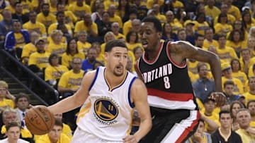 May 3, 2016; Oakland, CA, USA; Golden State Warriors guard Klay Thompson (11) dribbles the basketball against Portland Trail Blazers forward Al-Farouq Aminu (8) during the third quarter in game two of the second round of the NBA Playoffs at Oracle Arena. The Warriors defeated the Trail Blazers 110-99. Mandatory Credit: Kyle Terada-USA TODAY Sports