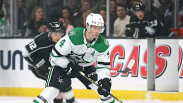 LOS ANGELES, CALIFORNIA - DECEMBER 09: Miro Heiskanen #4 of the Dallas Stars skates in with the puck in front of Trevor Moore #12 of the Los Angeles Kings during the first period at Staples Center on December 09, 2021 in Los Angeles, California. (Photo by Harry How/Getty Images)