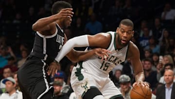 Mar 13, 2016; Brooklyn, NY, USA; Milwaukee Bucks center Greg Monroe (15) dribbles the ball guarded by Brooklyn Nets forward Thaddeus Young (30) in the first half at Barclays Center. Milwaukee defeats Brooklyn 109-100. Mandatory Credit: William Hauser-USA TODAY Sports