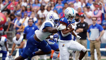 LAWRENCE, KANSAS - AUGUST 31: Wide receiver Andrew Parchment #4 of the Kansas Jayhawks carries the ball as linebacker Jonas Griffith #46 of the Indiana State Sycamores defends during the game at Memorial Stadium on August 31, 2019 in Lawrence, Kansas. (Photo by Jamie Squire/Getty Images)