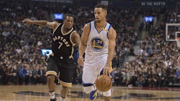 Nov 16, 2016; Toronto, Ontario, CAN; Golden State Warriors guard Stephen Curry (30) dribbles a ball as Toronto Raptors guard Kyle Lowry (7) defends during the first quarter at Air Canada Centre. Mandatory Credit: Nick Turchiaro-USA TODAY Sports
