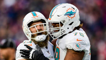 FOXBOROUGH, MA - DECEMBER 29: Ryan Fitzpatrick #14 of the Miami Dolphins reacts with Adam Pankey #78 after throwing the game winning touchdown pass during the fourth quarter of a game against the New England Patriots at Gillette Stadium on December 29, 2019 in Foxborough, Massachusetts. (Photo by Billie Weiss/Getty Images)