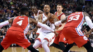 Apr 12, 2016; Toronto, Ontario, CAN; Toronto Raptors guard Norman Powell (24) looks to make a pass against Philadelphia 76ers center Nerlens Noel (4) and forward Robert Covington (33) in the second half at Air Canada Centre. Mandatory Credit: Dan Hamilton-USA TODAY Sports