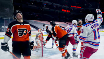 PHILADELPHIA, PENNSYLVANIA - FEBRUARY 24: Joel Farabee #86 of the Philadelphia Flyers and Ryan Strome #16 of the New York Rangers react following a goal by Chris Kreider #20 of the New York Rangers during the second period at Wells Fargo Center on February 24, 2021 in Philadelphia, Pennsylvania. (Photo by Tim Nwachukwu/Getty Images)