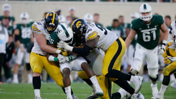 EAST LANSING, MI - SEPTEMBER 30: "nWide receiver Darrell Stewart Jr. #25 of the Michigan State Spartans is tackled by defensive end Parker Hesse #40 of the Iowa Hawkeyes and defensive lineman Cedrick Lattimore #95 of the Iowa Hawkeyes of the Iowa Hawkeyes during the second half at Spartan Stadium on September 30, 2017 in East Lansing, Michigan. (Photo by Duane Burleson/Getty Images)