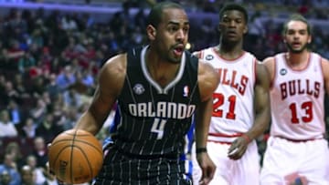 Apr 14, 2014; Chicago, IL, USA; Orlando Magic guard Arron Afflalo (4) dribbles the ball ball past Chicago Bulls guard Jimmy Butler (21) during the first quarter at the United Center. Mandatory Credit: Mike DiNovo-USA TODAY Sports