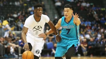 Jan 10, 2016; Denver, CO, USA; Denver Nuggets guard Emmanuel Mudiay (0) brings the ball up the court against Charlotte Hornets guard Jeremy Lin (7) during the first half at Pepsi Center. Mandatory Credit: Chris Humphreys-USA TODAY Sports