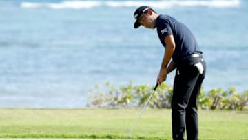 HONOLULU, HAWAII - JANUARY 16: Kevin Na of the United States putts on the 17th green during the third round of the Sony Open in Hawaii at the Waialae Country Club on January 16, 2021 in Honolulu, Hawaii. (Photo by Cliff Hawkins/Getty Images)